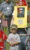 Four-year-old Kolby Jensen stands at attention during the playing of the Marine Corp Hymn. His mother Kim Jensen of North Salt Lake holds a picture of Kolby's older brother Whit Bell, who is in Iraq. The two were at the rally to support the troops at Liberty Park in Salt Lake City. <a href=