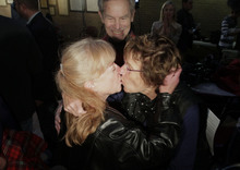   Leah Hogsten  |  The Salt Lake Tribune
Lucinda Bateman, left, kisses her spous,e Peggy Tomsic, before their marriage official Salt Lake County Mayor Ralph Becker in the lobby of the Salt Lake County offices, Friday December 20, 2013. Several hundred people descended on the Salt Lake County Clerk's Office Friday afternoon to get licenses. U.S. District Court Judge Robert J. Shelby in Utah Friday struck down the state's ban on same-sex marriage, saying the law violates the U.S. Constitution's guarantees of equal protection and due process.  