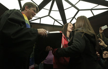   Leah Hogsten  |  The Salt Lake Tribune
l-r Chantel Buhler and spouse Laura Fernandez  are officially married by the Rev. Curtis L. Price in the lobby of the Salt Lake County offices, Friday December 20, 2013. Several hundred people descended on the Salt Lake County Clerk's Office Friday afternoon to get licenses. U.S. District Court Judge Robert J. Shelby in Utah Friday struck down the state's ban on same-sex marriage, saying the law violates the U.S. Constitution's guarantees of equal protection and due process.  