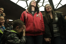   Leah Hogsten  |  The Salt Lake Tribune
l-r Chantel Buhler and spouse Laura Fernandez  giggle at their son Kayson, 4, after the two were officially married by the Rev. Curtis L. Price in the lobby of the Salt Lake County offices, Friday December 20, 2013. Several hundred people descended on the Salt Lake County Clerk's Office Friday afternoon to get licenses. U.S. District Court Judge Robert J. Shelby in Utah Friday struck down the state's ban on same-sex marriage, saying the law violates the U.S. Constitution's guarantees of equal protection and due process.  