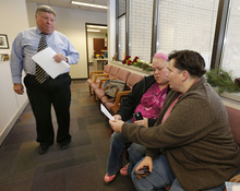   Utah County Clerk and Auditor Bryan Thompson Left, hands out rejection letter for a marriage license to Raylynn Marvel Center, and Patsy Carter right, from Orem, Utah, in the offices of the Utah County Clerk and Auditor office on Dec. 20, 2013 in Provo, Utah. A federal Judge on Friday struck down Utah's ban on same sex marriage saying the law violates the U.S. Constitution.  (Photo by George Frey  |  Special to the Tribune)  