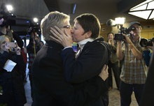   Scott Sommerdorf   |  The Salt Lake Tribune
Laurie Wood, left, and Kody Partridge, kiss after being told that they are officially married by the Rev. Curtis L. Price in the lobby of the Salt Lake County offices, Friday December 20, 2013.  