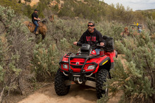   Trent Nelson  |  The Salt Lake Tribune
Under the eyes of a mounted San Juan County Sheriff's Deputy, motorized vehicles make their way into Recapture Canyon, which has been closed to motorized use since 2007. The protest on Saturday, May 10, 2014, north of Blanding, came after a call-to-action by San Juan County Commissioner Phil Lyman.  