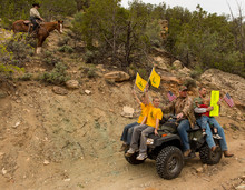   Trent Nelson  |  The Salt Lake Tribune
Under the eyes of a mounted Kane County Sheriff's Deputy, ATV riders make their way into Recapture Canyon, which has been closed to motorized use since 2007. The protest on Saturday, May 10, 2014, north of Blanding, came after a call-to-action by San Juan County Commissioner Phil Lyman.  
