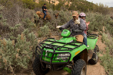   Trent Nelson  |  The Salt Lake Tribune
Under the eyes of a mounted San Juan County Sheriff's Deputy, ATV riders make their way through Recapture Canyon, which has been closed to motorized use since 2007. The protest on Saturday, May 10, 2014, north of Blanding, came after a call-to-action by San Juan County Commissioner Phil Lyman.  