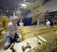   Al Hartmann  |  The Salt Lake Tribune
Designer-builder, Monique Lanier, Jolene Mewing and Chris Johnson with the Utah Pride Center put finishing touches on the Grand Marshal's float for the 2014 Utah Pride Parade next weekend. The three same-sex couples that were plaintiffs in federal court that struck down Utah's ban on same sex marriage law will ride on the float.  