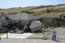   Al Hartmann  |  The Salt Lake Tribune 
A home destroyed by landslide at Parkway Dr. in North Salt Lake. Residents returned to their homes Wednesday Aug. 6, 2014, a day after a landslide destroyed the home and others had to be evacuated.  