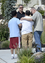   Al Hartmann  |  The Salt Lake Tribune 
Neighbors console members of the Utrilla family (Ismael Utrilla in red shorts) after touring their home that was destroyed in a landslide in North Salt Lake. Residents returned to homes along Parkway Drive in North Salt Lake Wednesday Aug. 6, 2014, a day after a landslide destroyed the home and others had to be evacuated.  