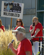   Leah Hogsten  |  The Salt Lake Tribune
Melissa Kennedy (right) daughter of West Valley Police shooting fatality Danielle Willard records the speech of Mike Stewart who talks of his son Matthew David Stewart and the Weber County Strike Force at the Families Speak Out On Police Violence rally Saturday, October 4, 2014, at the Matheson Courthouse.   