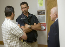   Al Hartmann  |  The Salt Lake Tribune

Defendants charged in the archaelogical looting investigation make their initial  appearance in federal court in Moab Thursday morning.   Mike Wingert with the U.S Marshall Service left, talks with BLM special agent Dan Love outside the courtroom.  Court security officer Del Badham at right.  