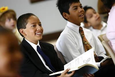 Neftali Montoya, 11, left, and Henry Martinez, 11, participate in the Spanish-speaking LDS service for children at the Lighthouse Branch.