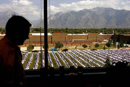 Todd Wilkerson looks out of his office window at the field of flags near the Sandy City Hall.