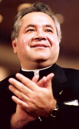 Auxiliary Bishop Gabino Zavala of Los Angeles applauds at a U.S. bishops' meeting in this 1994 file photo. Bishop Zavala took office as bishop-president of Pax Christi USA during its national assembly in New York Aug. 1-3.