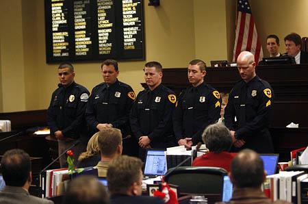 The Salt Lake Tribune  Ogden police Officer Kenneth Hammond, far left, and Salt Lake City police Officers Brett Olsen, Dustin Marshall, Josh Scharman and Andy Oblad are honored Friday in the Utah Legislature for saving lives at Trolley Square. In the photo below, Debra, center, and Ronn Marshall, parents of Dustin Marshall, watch the ceremony with his children Jordan, 8, bottom left and Taylor, 10.