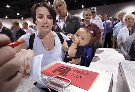 Kat Dayton, of Salt Lake City, with son Oscar in tow, casts her ballot at the Utah GOP's annual convention at the South Towne Expo Center on Saturday.
