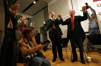 Playfully trying to silence the cheering crowd, University of Utah's world-renowned geneticist Mario R. Capecchi is celebrated at the Eccles Institute for Human Genetics at the University of Utah after receiving the Nobel Prize Monday.