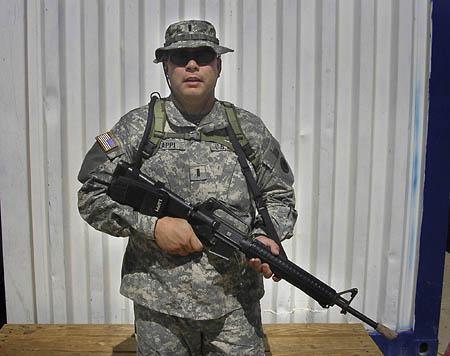 Lt. Joseph Lappi shown holding his automatic rifle while serving in Ramadi, Iraq with the 222nd Field Artillery. He is now home in Utah taking care of his children and dealing with a divorce.
