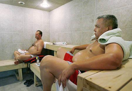 Police Officer Al Acosta, of Sandy, right, and retired officer Kelly Call, of Roy, relax in a 160-degree sauna at the Bio Cleansing Centers of America in Orem on Wednesday as they go through a program designed to rid their bodies of toxins they were exposed to in the late 1980s while processing meth labs.