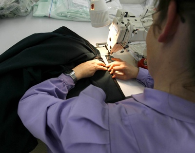 A woman at work making dresses in the sewing facility at the FLDS Church's YFZ ranch in Texas.
