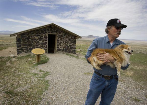 Lynn Drollinger of Stansbury Park holds his dog Foxy take in the view a the Simpson Springs Pony Express Station is silent along the Pony Express Trail Monday, April 27, 2009 in Utah's west desert. Drollinger noted that there was a lot to find in the desert of you knew where to look. The station was operated from 1860 to 1860. (FOR WHARTONS WEST DESERT STORY). Jim Urquhart/The Salt Lake Tribune; 4/27/09