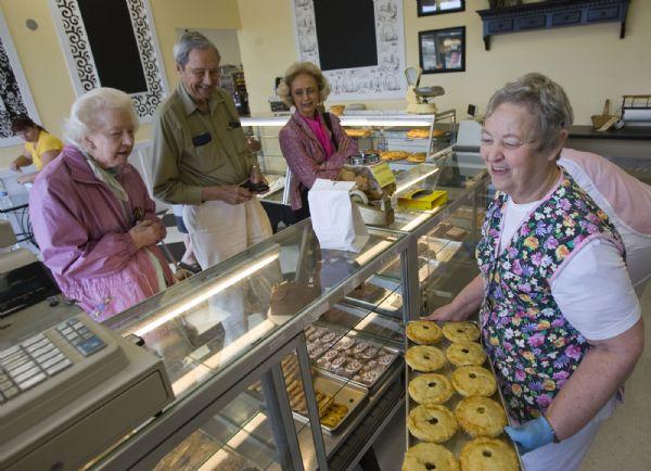 After 34 years in business, Leslie's Bakery has moved down the street to a new home. The popular Holladay bakery had to relocate as part of construction that is happening on the Holladay Village Center.  Old customers Mary Alice Breitling, left, Thomas O. Breitling and Dona Lauderdale stop in the new location at 2308 Murray-Holladay Road  Friday morning. 14 year employee Nadine Chase, right, stocks the cases with meat pies.    Al Hartmann/The Salt Lake Tribune   5/22/09