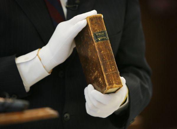 The gloved hands of Church Historian Marlin Jensen hold a first-edition of The Book of Mormon once owned by James H. Moyle in 1906. This was one of the rare Church artifacts shown, along with a state-of-the-art storage vault and conservation lab that are now on display in the new LDS Church History Library.

Scott Sommerdorf/The Salt Lake Tribune