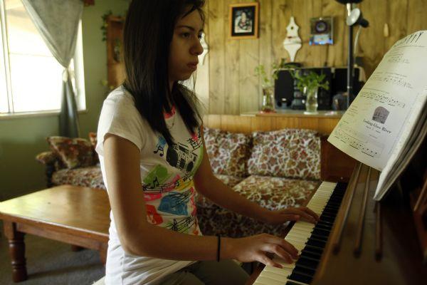 Jimena Arellano, 17, practices the piano at her home in Salt Lake City May 28, 2009. Arellano received the piano two years ago through the Mundi Piano Project.



Chris Detrick/The Salt Lake Tribune