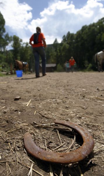 Camp Roger-  A horse shoe rests on the ground as campers at Camp Roger, near Kamas, leave the stables for a snack Wednesday Jul 22, 2009.  Steve Griffin/The Salt Lake Tribune 7/22/09