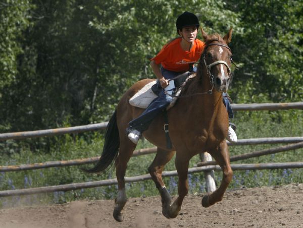 Camp Roger- Ariana Bustos, 12, of Sandy, rides her horse in the riding