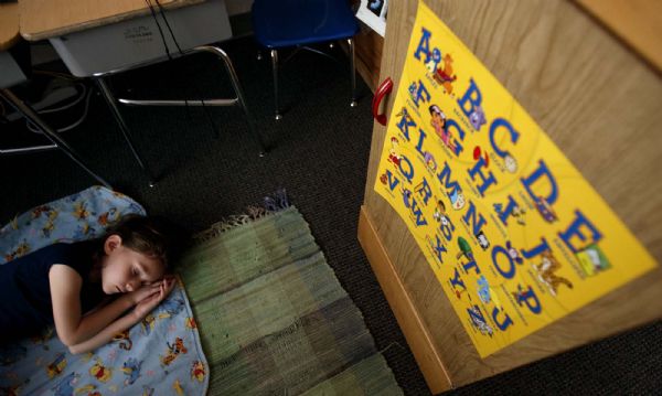 Salt Lake City - Kindergarten student Phoebe Klein rests during naptime at Whittier Elementary in teacher Betsy Haslam's class, Tuesday, August 18 2009. As school starts, tens of thousands of kindergarten students will be taking similar tests. The results are used to tailor instruction to their individual needs and to track student performance. Nationally and locally, there is ample proof that all-day kindergarten works to bridge the achievement gap for at-risk students. But it's not universally available in Utah and funding is uncertain.

Trent Nelson/The Salt Lake Tribune; 8.18.2009