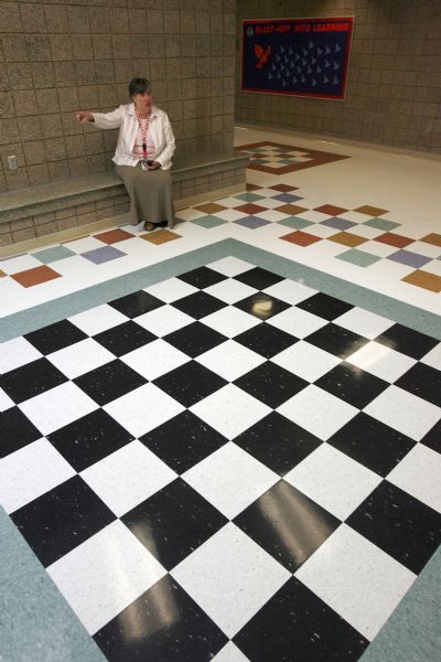 West Valley City - Diamond Ridge elementary school principal Debbie Koji speaks proundly of her idea to use some of the leftover tile to contruct a chess board on the floor of the newly opened school in the Diamond Summit subdivision of West Valley City. Photo by Francisco Kjolseth/The Salt Lake Tribune 8/26/2009