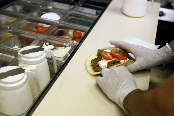 Owner Jorge Daskalakis makes a traditional the beef and lamb gyro ($6.48) at Dasks restaurant in Holladay Tuesday September 1, 2009. 

Photo by Chris Detrick/The Salt Lake Tribune