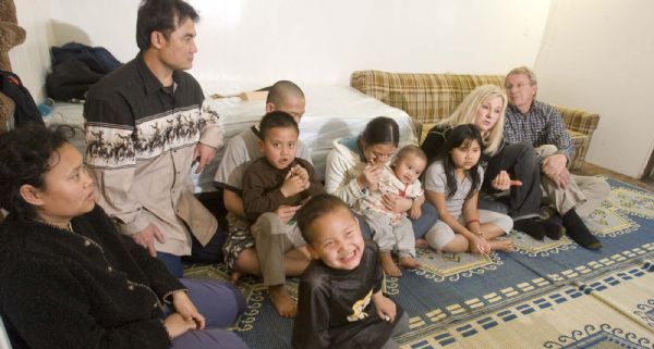 The Sein Family sit in their apartment with Maryanne and Jim Webster (far right)on  Monday, December 21,2009.  The Websters are service missionaries for the LDS Church.  THe family from left are Hser Eh Dah Sein, her husband Sar Sein,  Eh Roh Jet  sitting in his brother Eh Ah Ah Doh's lap, Jet De Love (17months) sitting on sister Eh Doh Doh Lah's lap, Hser Eh Doh, and  John (age 4 in front) photo:Paul Fraughton/ The Salt Lake Tribune