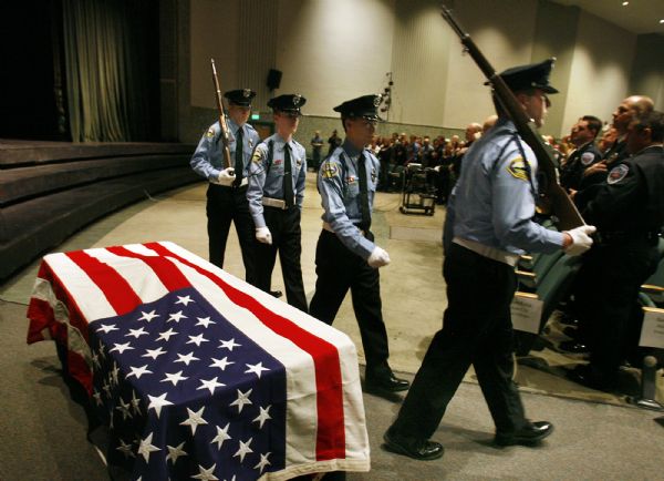 Scott Sommerdorf  |  Salt Lake Tribune
The Sandy City Color Guard on Saturday passes the flag-draped urn holding 