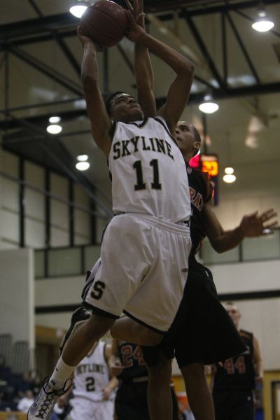 Photo by Chris Detrick  |  The Salt Lake Tribune 
Skyline's Taurus Dickerson, #11, shoots past Murray's Julian Moore, #15, during the game at Skyline High school Tuesday, January 19, 2010.