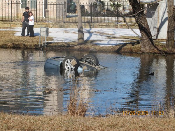 In this Dec. 26, 2009 photo released by Roberts & Roberts law firm, a scene of a deadly crash of the 2008 Toyota Avalon taken by the Southlake Police Department is shown. In the Texas crash, four people died when their 2008 Avalon ripped through a fence, hit a tree and flipped into an icy pond. Toyota has for years blocked access to data stored in devices similar to airline 