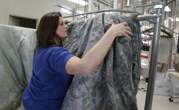 close up-  Manager Michelle Clark prepares blankets to be cleaned Tuesday, March 2 2010 at Martinizing in Layton. Martinizing Dry Cleaning is one of the oldest and the most recognized brands in the $7 billion dry cleaning industry. It is the largest dry cleaning franchisor in the United States with locations in eight other countries and U.S. Territories.3/2/10