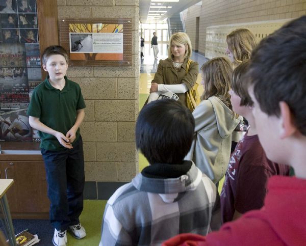 Students gather in small groups  to learn about the energy saving and ecological features of the new Hillside Middle School  Joshua Watson, a 7th grader talks about the  features in the building helping with the air quality .Students from Beacon Heights Elementary toured the new Hillside Middle School  on  Wednesday, March 24,2010  photo:Paul Fraughton/ The Salt Lake Tribune