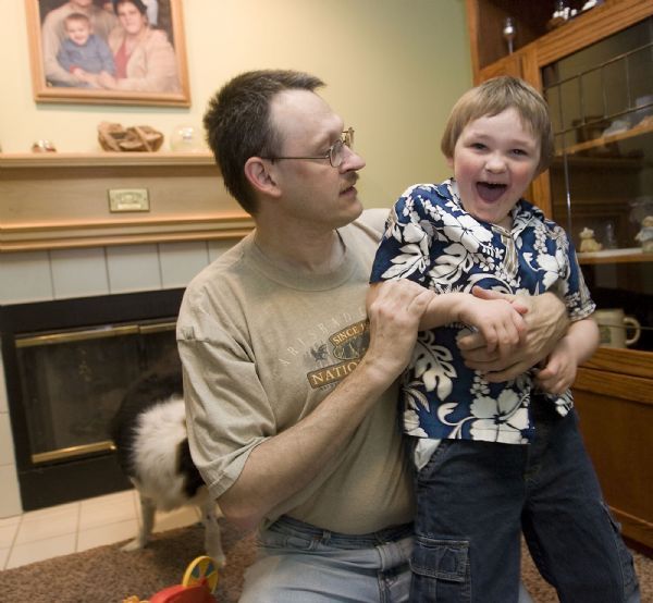 Al Hartmann  |  The Salt Lake Tribune   5/6/2010
Chris Gilbert cares for his six-year-old son Aiden who has Angelman Syndrome.  He and his wife Michelle work hard to provide what's best for Aiden.  Angelman syndrome is a life-long, neuro-genetic disorder that exhibits symptoms of developmental delay, lack of speech, seizures, inappropriate laughter, and walking and balance disorders. The Gilberts love for theirr child continues to motivate them to aggressively fundraise for the Angelman Syndrome Foundation, a non-profit committed to improving the lives of those with Angelman syndrome through research, education, and advocacy.