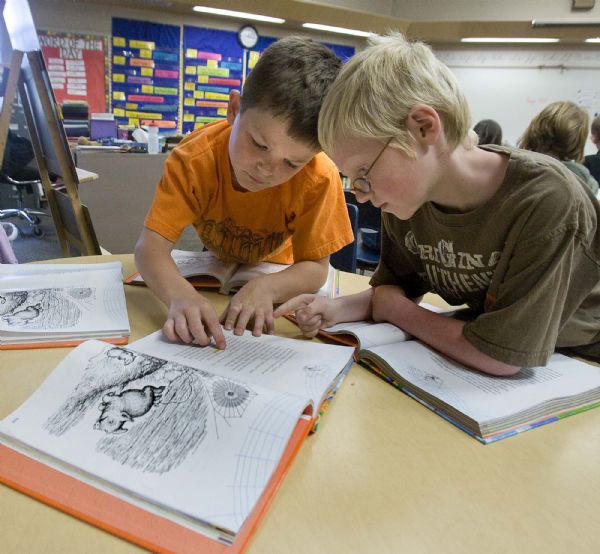 Paul Fraughton  |  The Salt Lake Tribune
Parkside Elementary third-graders, Logan Jones, left, and Patrick O'Brien help each other with their reading Tuesday.
