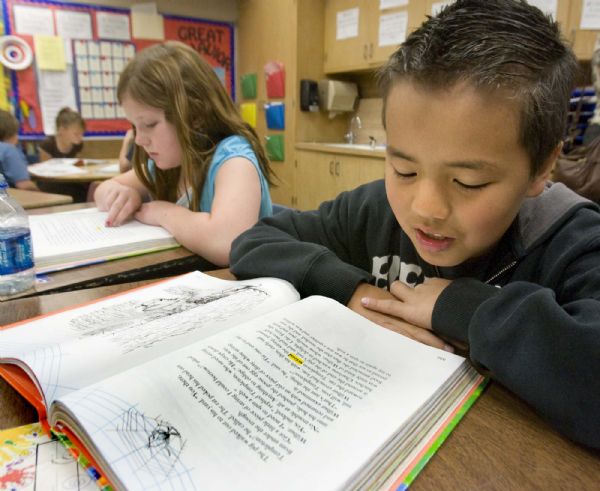 A third grader at Parkside Elementary in the Murray School District,Justin Walljasper reads aloud  as his reading partner Geniah Stuber follows along in her book. on  Tuesday, May 18,2010  photo:Paul Fraughton/ The Salt Lake Tribune