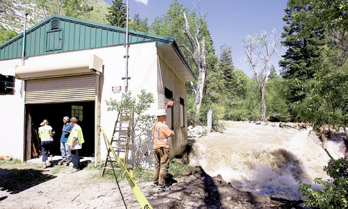 Steve Griffin  |  The Salt Lake Tribune&#xA;&#xA;Salt Lake County - High water and debris in Little Cottonwood Creek has caused the raging water to start to undermine the foundation of this small privately owned power plant about 1.5 miles up Little Cottonwood Canyon. A small metal footbridge that spanned the creek was lifted away by a crane in hopes that it would free the debris but it didn't. County crews were going to use a back hoe to try and free the debris later in the evening Monday Jun 7, 2010.