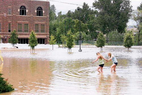 Two girls wade through the flood waters on Myrtle Ave. near Murray City Park  on  Monday, June 7,2010  photo:Paul Fraughton/ The Salt Lake Tribune&#xA;&#xA;&#xA;