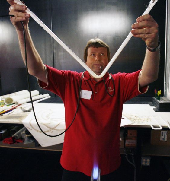Steve Griffin  |  The Salt Lake Tribune

Salt Lake City -  Talbot Hall, who has been with YESCO for 27 years, blow air into a neon tube as he bends it into a shape in the 