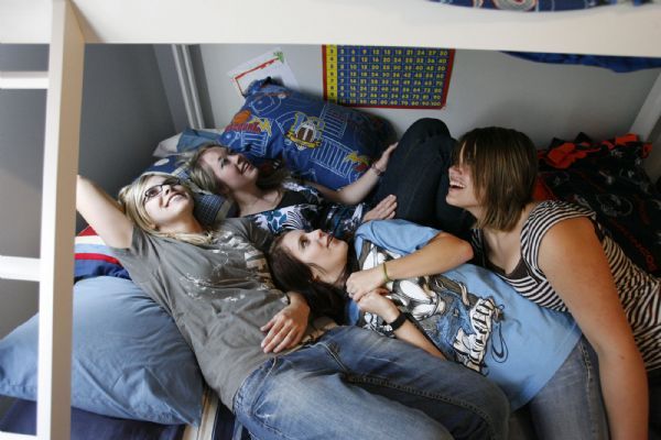 Steve Griffin  |  The Salt Lake Tribune

Antelope Island -  Nikel Taylor is joined by her friends in her bed, at her home on Antelope Island, as they read from a poster above her bed that was given to her by members of the Layton Fire Department after she graduated from EMT class earlier this year. The high school senior is preparing to move off the island where she has lived with her parents since she was nine-years-old.  Saturday May 22, 2010.