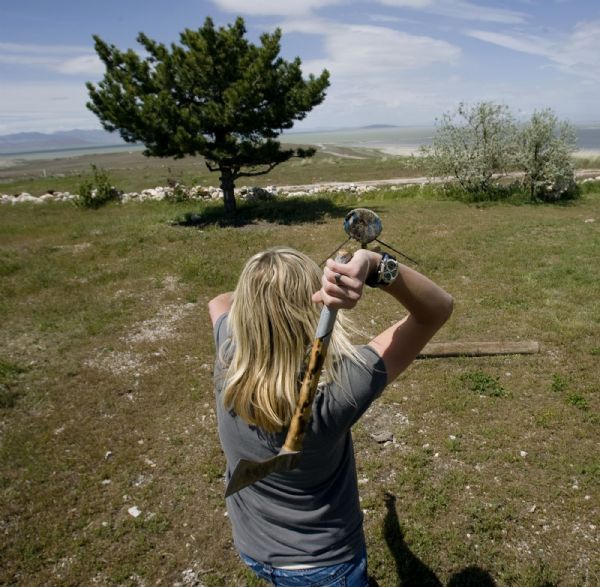 Steve Griffin  |  The Salt Lake Tribune

Nikel Taylor tosses a tomahawk at a wooden target outside her home on Antelope Island last month. The high school senior is preparing to move off the island where she has lived with her parents since she was 9 years old.