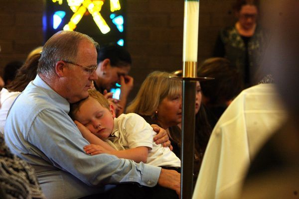 Leah Hogsten  |  The Salt Lake Tribune
With the casket of   Sister Mary Joseph (Barbara) Whipperman at right, lifelong friend Tim Langan holds his sleeping grandson Peter Eggett, 5. Funeral services for   Sister Mary Joseph (Barbara) Whipperman at the Carmelite Monastery Chapel on Saturday July, 17, 2010. Sister Mary Joseph (Barbara) Whipperman, 77, died July 13, 2010 in Holladay, Utah. Born May 11, 1933, Salt Lake City, Utah, to Ernest and Edna Duncombe Whipperman. Raised in the LDS faith, she worked as a nurse's aide at LDS Hospital, and then enrolled in Brigham Young University's nursing program. She graduated with honors in 1956, beginning a career as a public health nurse in Salt Lake City. She entered the Carmelite Order in 1963.