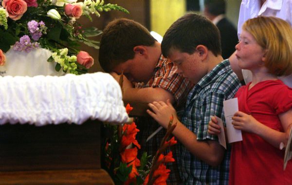 Leah Hogsten  |  The Salt Lake Tribune
l-r Nicholas Crofoot, 10, John Paul Crofoot, 9, and Isabelle Crofoot, 5, pay their respects to their close family friend. Funeral services for   Sister Mary Joseph (Barbara) Whipperman at the Carmelite Monastery Chapel on Saturday July, 17, 2010. Sister Mary Joseph (Barbara) Whipperman, 77, died July 13, 2010 in Holladay, Utah. Born May 11, 1933, Salt Lake City, Utah, to Ernest and Edna Duncombe Whipperman. Raised in the LDS faith, she worked as a nurse's aide at LDS Hospital, and then enrolled in Brigham Young University's nursing program. She graduated with honors in 1956, beginning a career as a public health nurse in Salt Lake City. She entered the Carmelite Order in 1963.