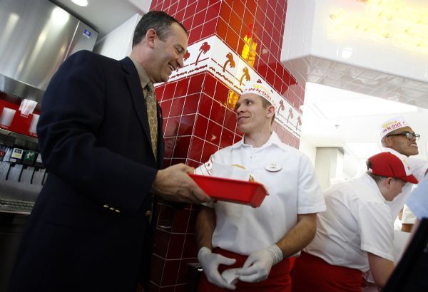 Leah Hogsten  |  The Salt Lake Tribune
WVC Manager Wayne Pyle picks up his order from James Berejkoff (right). 
The WVC City Council and mayor attended the VIP party on Tuesday evening before the In-N-Out Burger grand opening. In-N-Out Burger is opening two stores Wednesday in West Valley City and Riverton, bringing the grand total of Utah stores to 7.  
 WVC 7/20/10