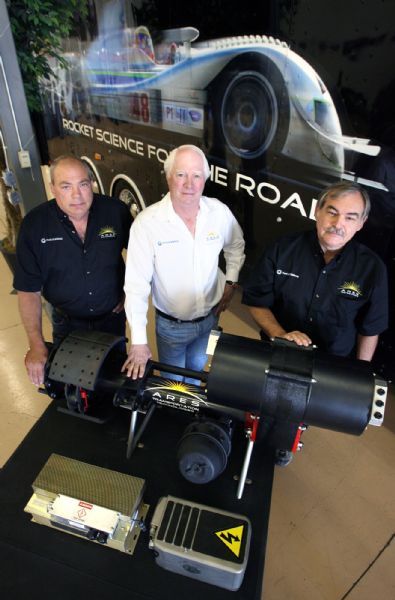 Steve Griffin  |  The Salt Lake Tribune

 Mike Strausbaugh, Steve Pruitt, and Alden Rix of Ares Motorsports with their trailer assistive drive system at the company's garage in Salt Lake City Thursday Jul 15, 2010. Pruitt has recently patented a system that will turn big diesel semitrucks into hybrids.